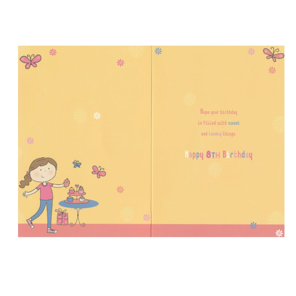 Front of this 8th birthday card features an illustration of a girl with cupcakes, paired with a message.