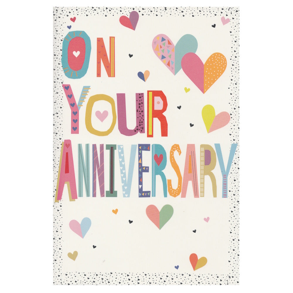 Front of this greeting card features colourful text 'On Your Anniversary' with heart designs on a white background.