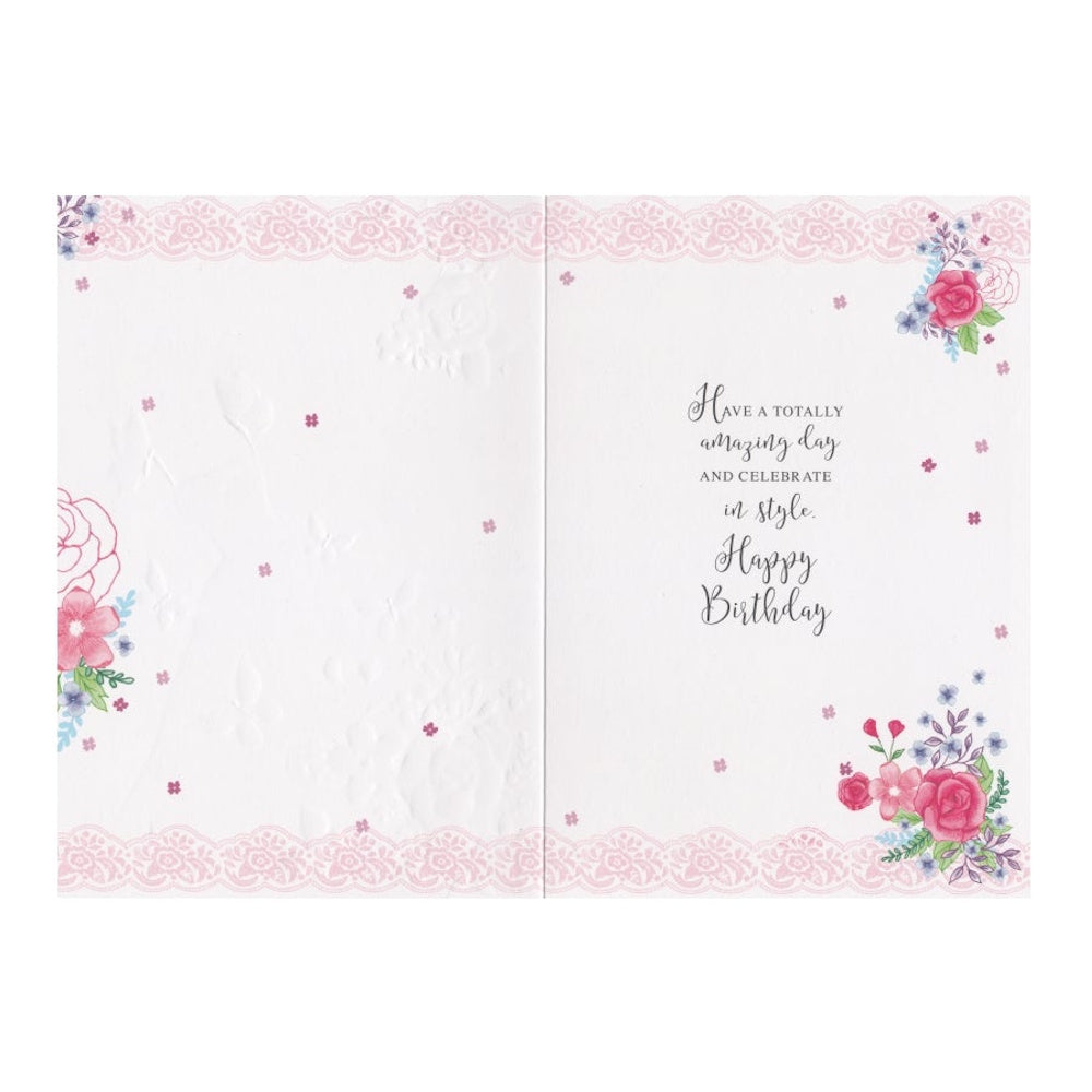 Front of this birthday card features illustrations of a blue dress, butterflies and flowers, paired with a message.