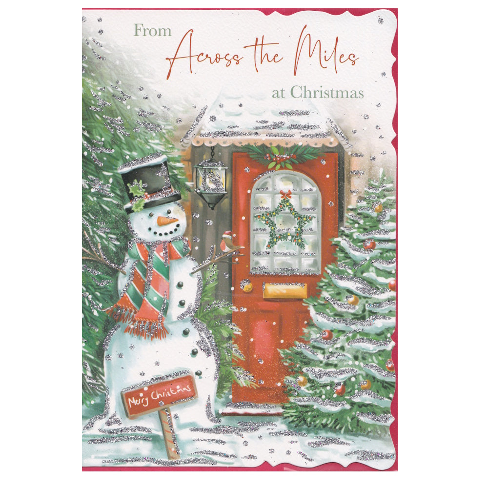 Front of this card features an illustration of a snowman with a front door decorated for Christmas, with the text 'From Across the Miles at Christmas'.