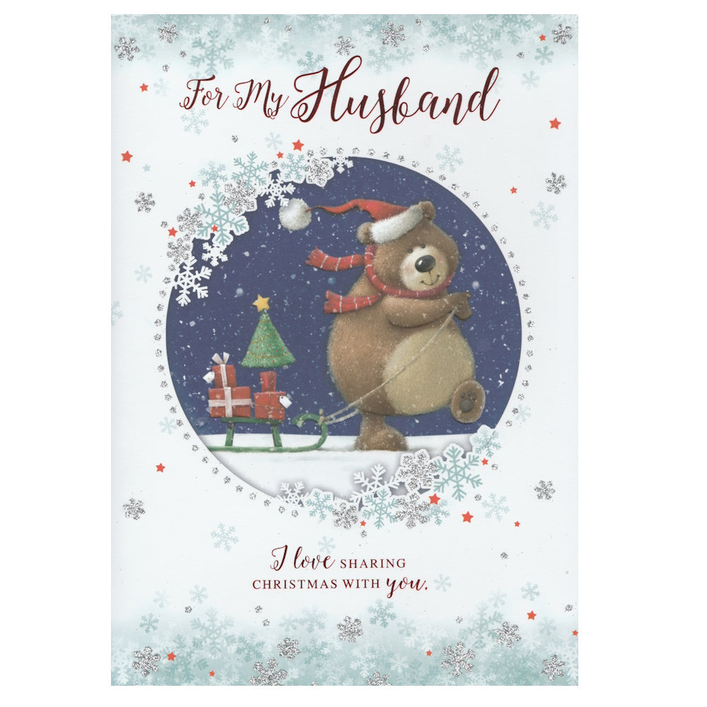 Front of this husband Christmas card features an illustration of a bear pulling a sleigh of presents, paired with a message.