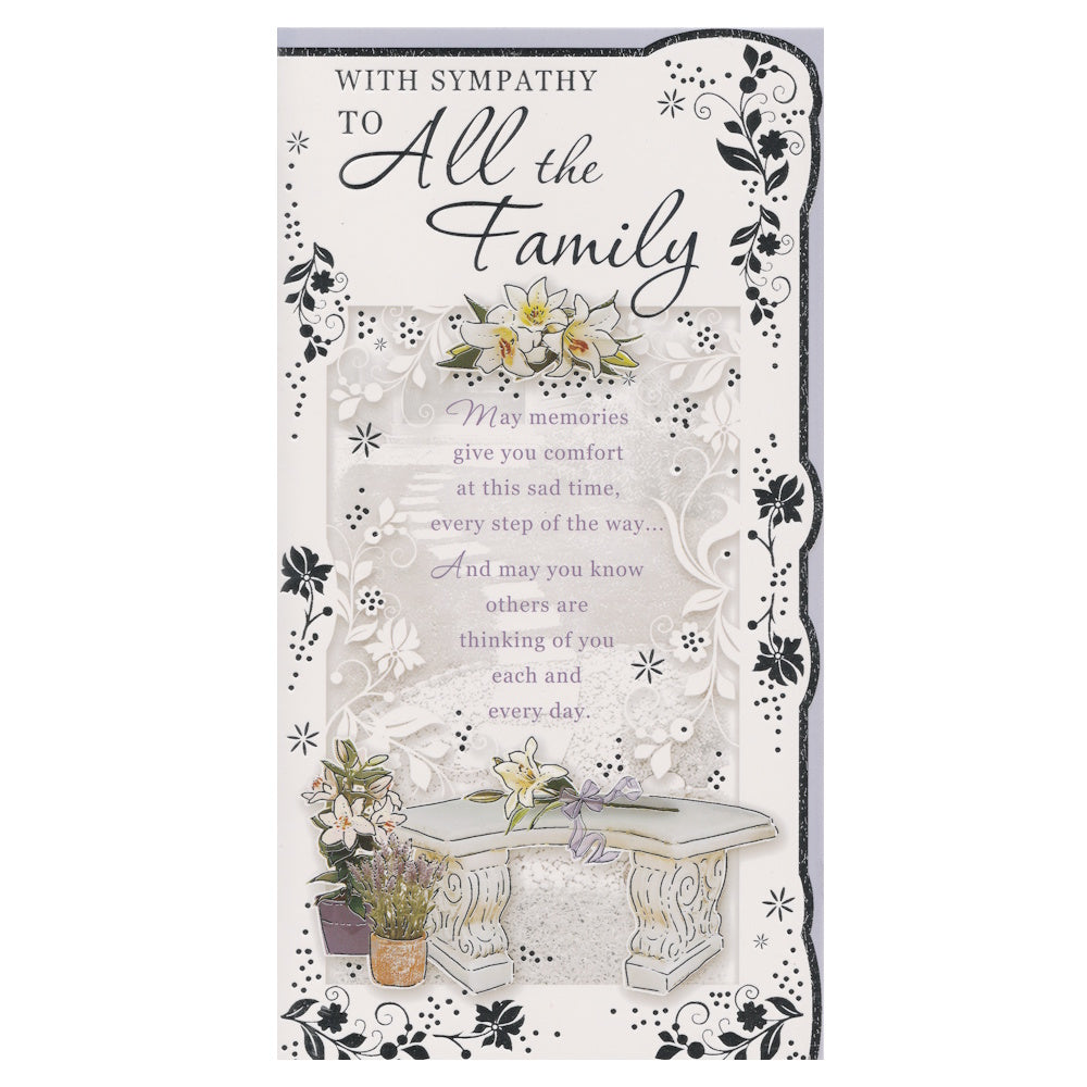 Front of this card features an illustration of lily flowers and a stone garden seat surrounded by silver flowers and border, paired with a message.