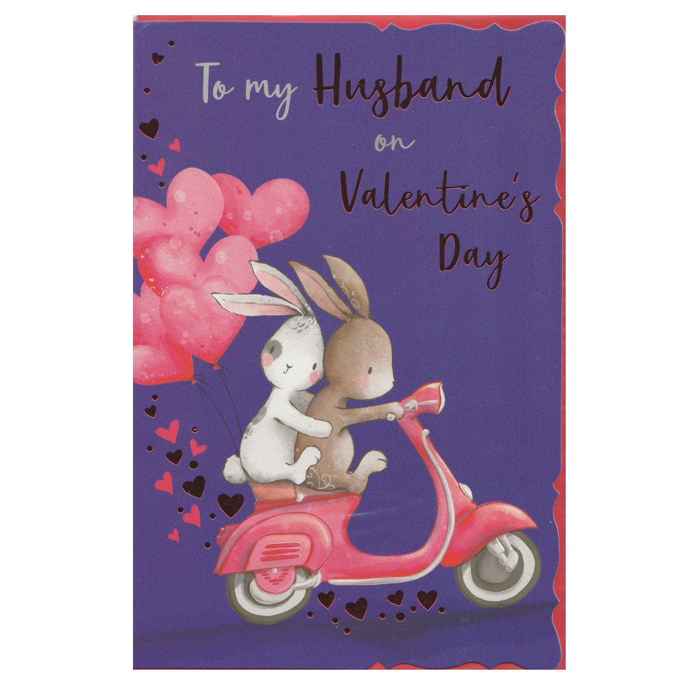 Front of this card features an illustration of two rabbits, with heart shaped balloons, riding a scooter, surrounded by love hearts, paired with a message.