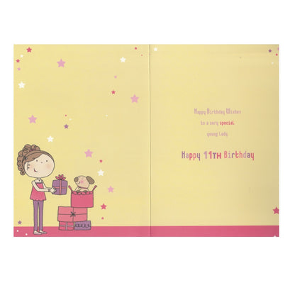 Front of this 11th birthday card features an illustration of a girl standing near a stack of presents, paired with a message.