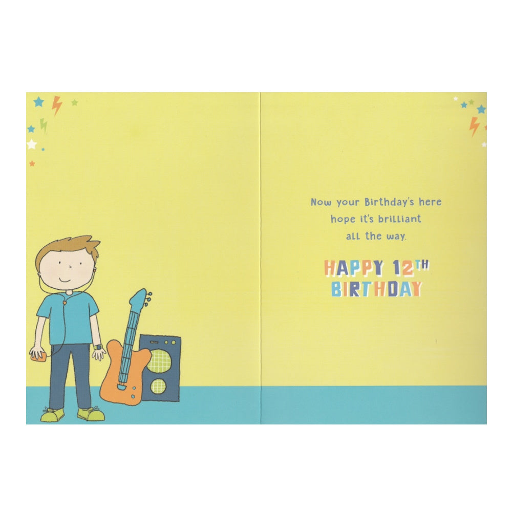 Front of this 12th birthday card features an illustration of a boy with a guitar and a guitar amp, paired with a message.