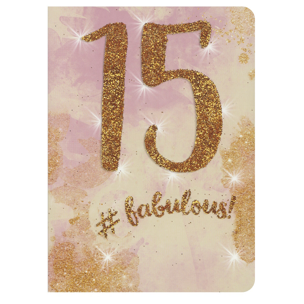 Front of this 15th birthday card features the text '15 #fabulous' on a gold and pink gradient background.
