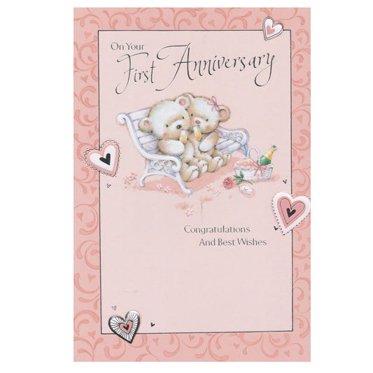 Front of this 1st anniversary card features an illustration of two teddy bears sitting on a bench drinking champagne, paired with a message.
