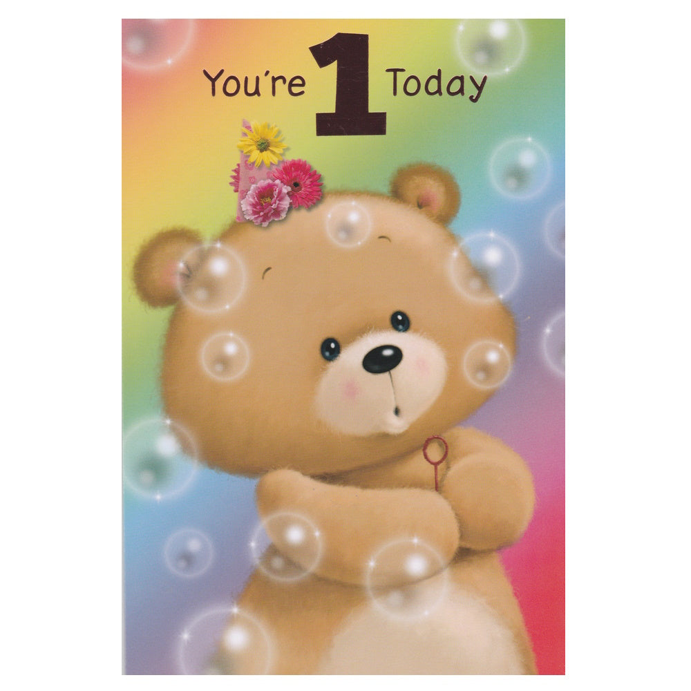Front of this 1st birthday card features an illustration of a teddy bear blowing bubbles, paired with a message.