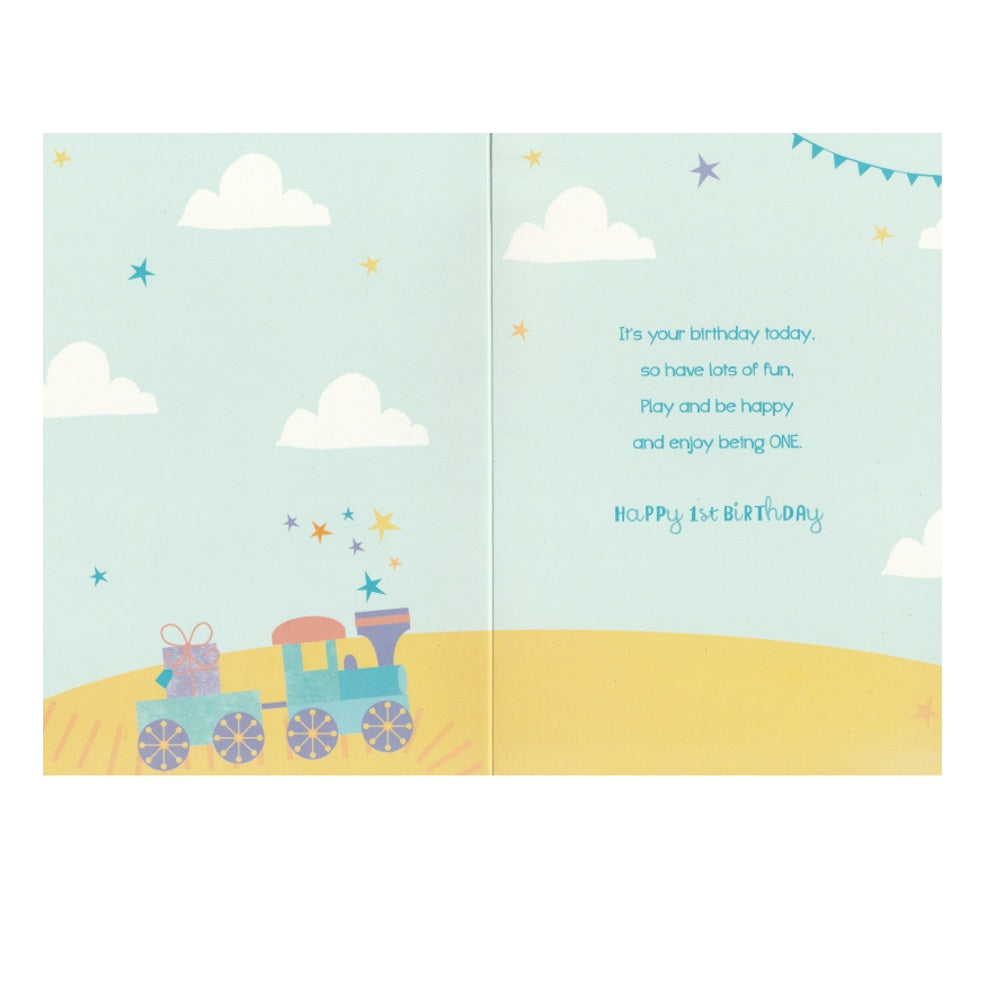 Front of this 1st birthday card features an illustration of a little boy playing with a teddy bear and train set, paired with a message.