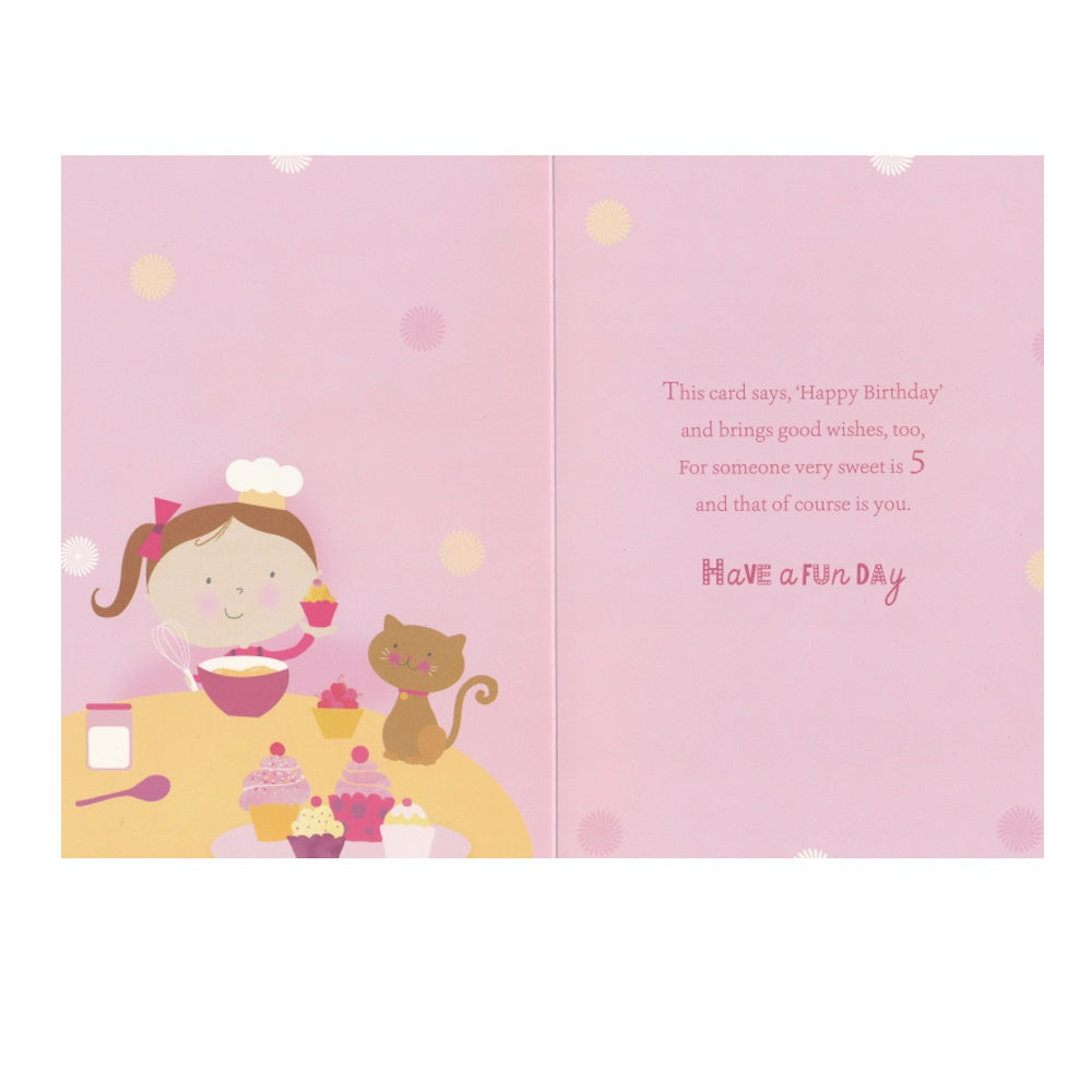 Front of this 5th birthday card features an illustration of a girl making cup cakes, paired with a message.