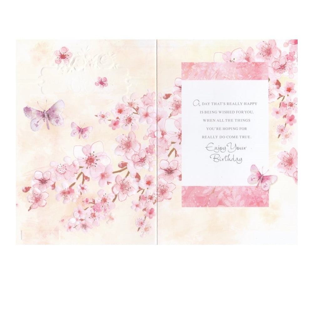 Front of this 60th birthday card features an illustration of a butterflies and pink flowers, paired with a message.