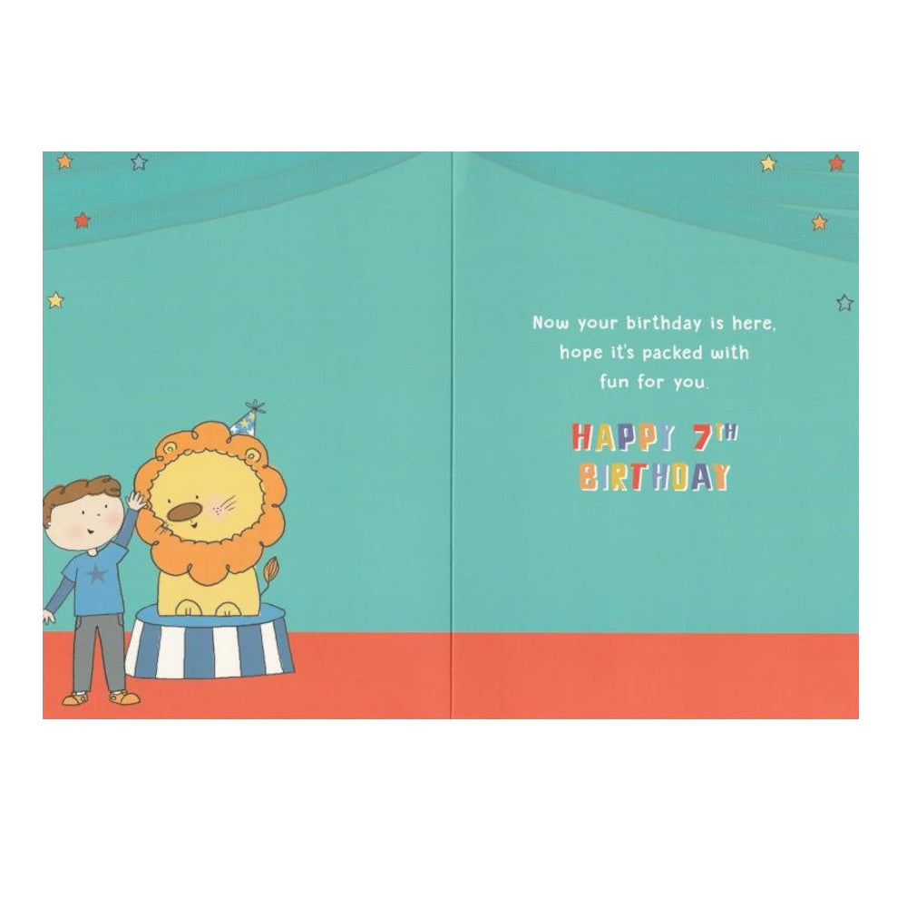 Front of this 7th birthday card features an illustration of a boy with a lion, paired with a message.