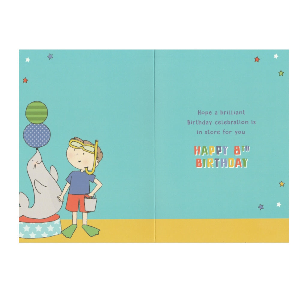 Front of this 8th birthday card features an illustration of a boy with a sea lion, paired with a message.