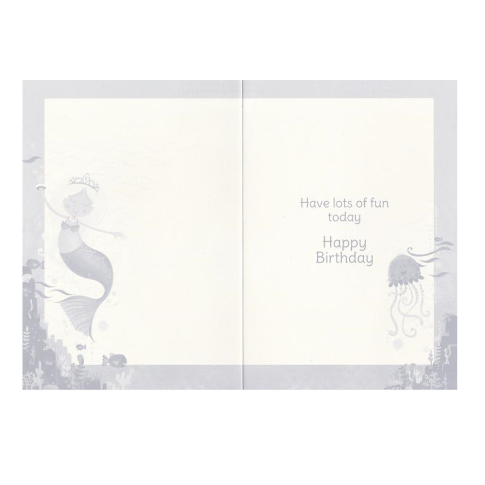 Front of this auntie birthday card features with an illustration of a yellow-haired mermaid in a blue dress with a crown and a pink jellyfish.