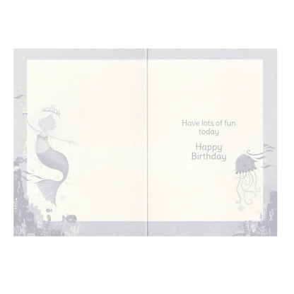 Front of this auntie birthday card features with an illustration of a yellow-haired mermaid in a blue dress with a crown and a pink jellyfish.