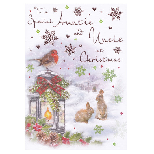 Front of this auntie and uncle Christmas card features an illustration of a lantern with a bow and a robin perched on top, paired with a message.