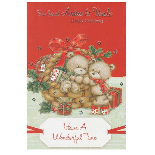 Front of this auntie and uncle Christmas card features an illustration of two teddy bears in a Christmas basket with presents, paired with a message.