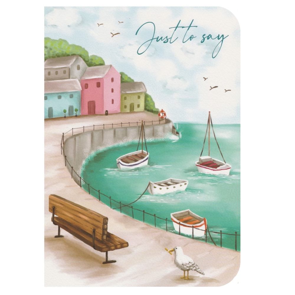 Front of this card features an illustration of a harbour scene, including boats, buildings, a bench and birds in the sky.
