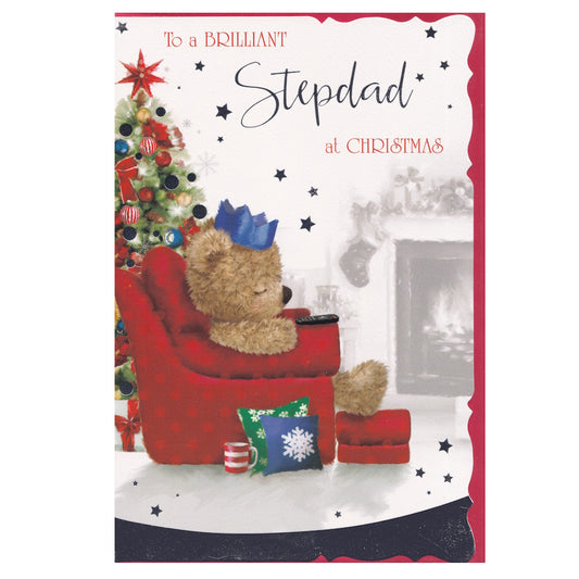 Front of this card features an illustration of a teddy bear asleep in a comfy chair with a decorated Christmas tree and the text 'To a BRILLIANT Stepdad at Christmas'.