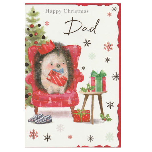 Front of this dad Christmas card features an illustration of an hedgehog sat in a armchair with a Christmas tree and presents, paired with a message.