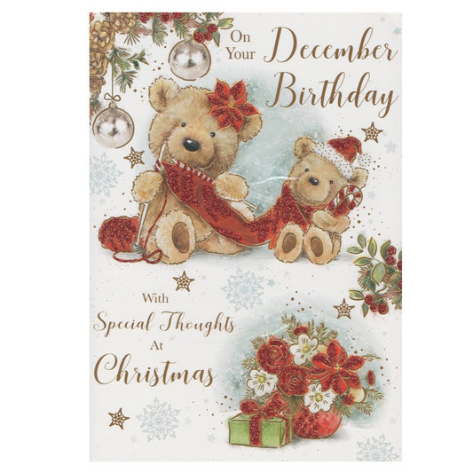Front of this December birthday card features an illustration of two teddy bears dressed for Christmas, paired with a message.