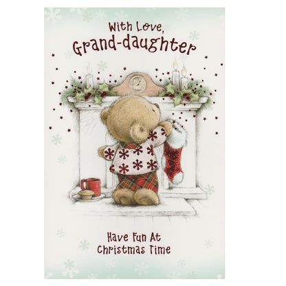 Front of this grand-daughter Christmas card features an illustration of a teddy bear hanging up a Christmas stocking on the fireplace, paired with a message.