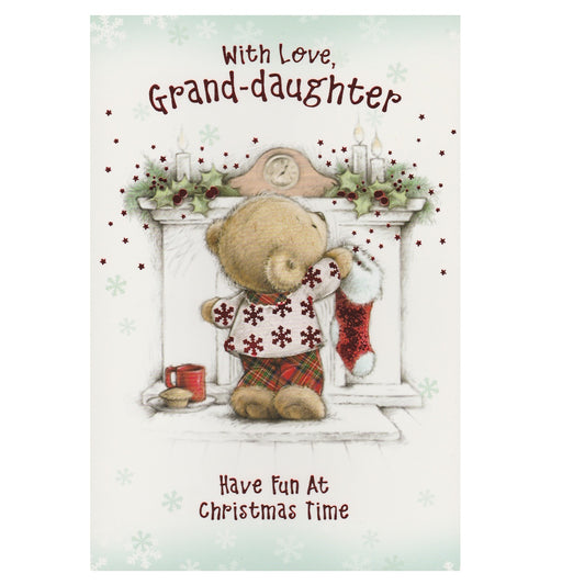 Front of this grand-daughter Christmas card features an illustration of a teddy bear hanging up a Christmas stocking on the fireplace, paired with a message.