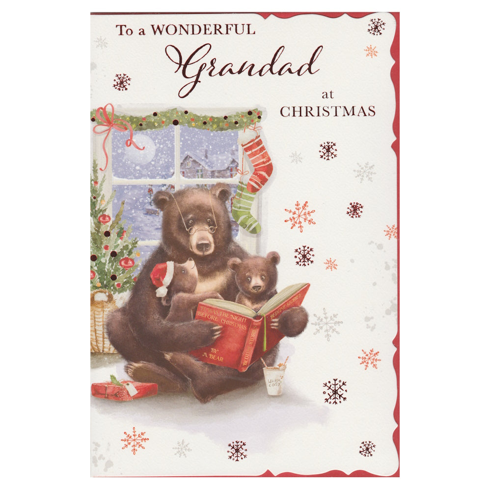 Front of this grandad Christmas card features an illustration of a grandad bear reading a book to two bear cubs, paired with a message.