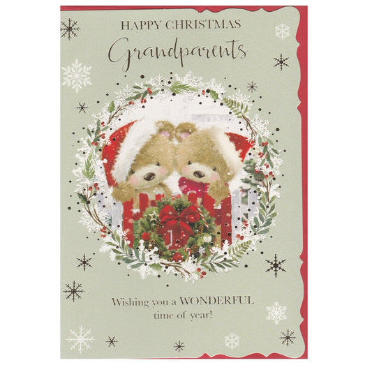 Front of this grandparents Christmas card features an illustration of two teddy bears wearing Christmas hats surrounded by a circle of holly, paired with a message.