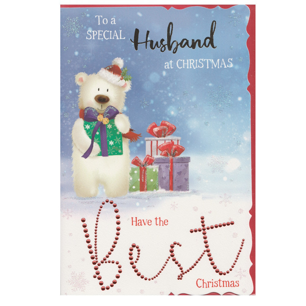 Front of this husband Christmas card features an illustration of a polar bear wearing a Christmas hat holding a wrapped gift with a blue bow, paired with a message.