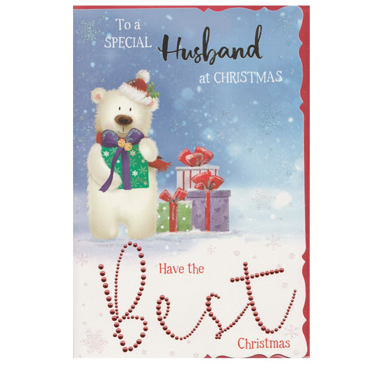 Front of this husband Christmas card features an illustration of a polar bear wearing a Christmas hat holding a wrapped gift with a blue bow, paired with a message.