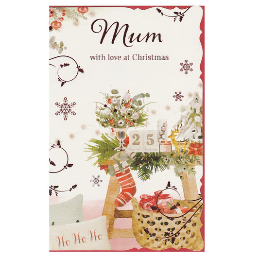 Front of this mum Christmas card features an illustration of a Christmas table setting with a striped stocking and a cushion with the text 'Ho Ho Ho', paired with a message.