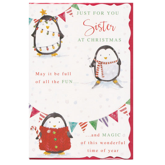 Front of this sister Christmas card features an illustration of three penguins decorated for Christmas, paired with a message.