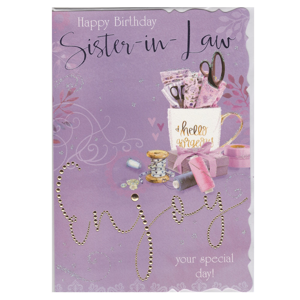 Front of this card features an illustration of mug filled with sewing supplies he text 'Happy Birthday Sister-in-Law' and 'Enjoy your special day!' on a purple background.