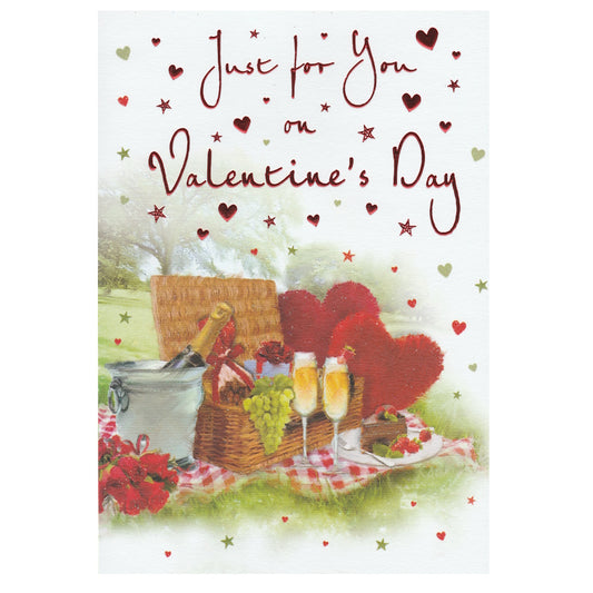 Front of this valentine's day card features an illustration of a romantic picnic scene, including a basket of food, glasses of champagne and hearts with the text 'Just for You on Valentine's Day''.